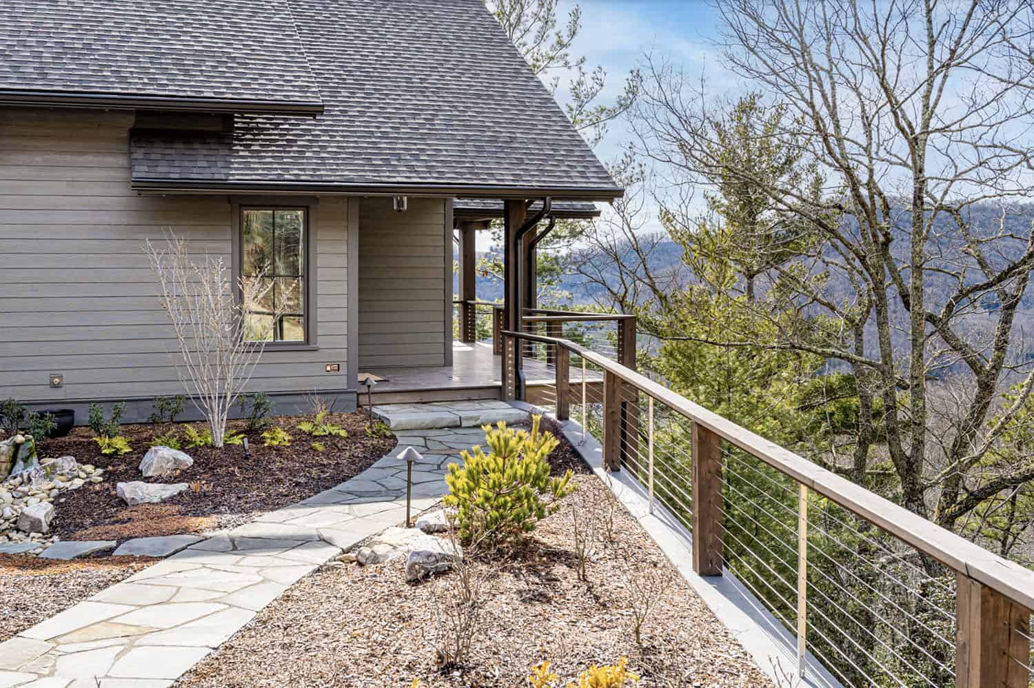 modern rustic mountain home exterior with a walkway