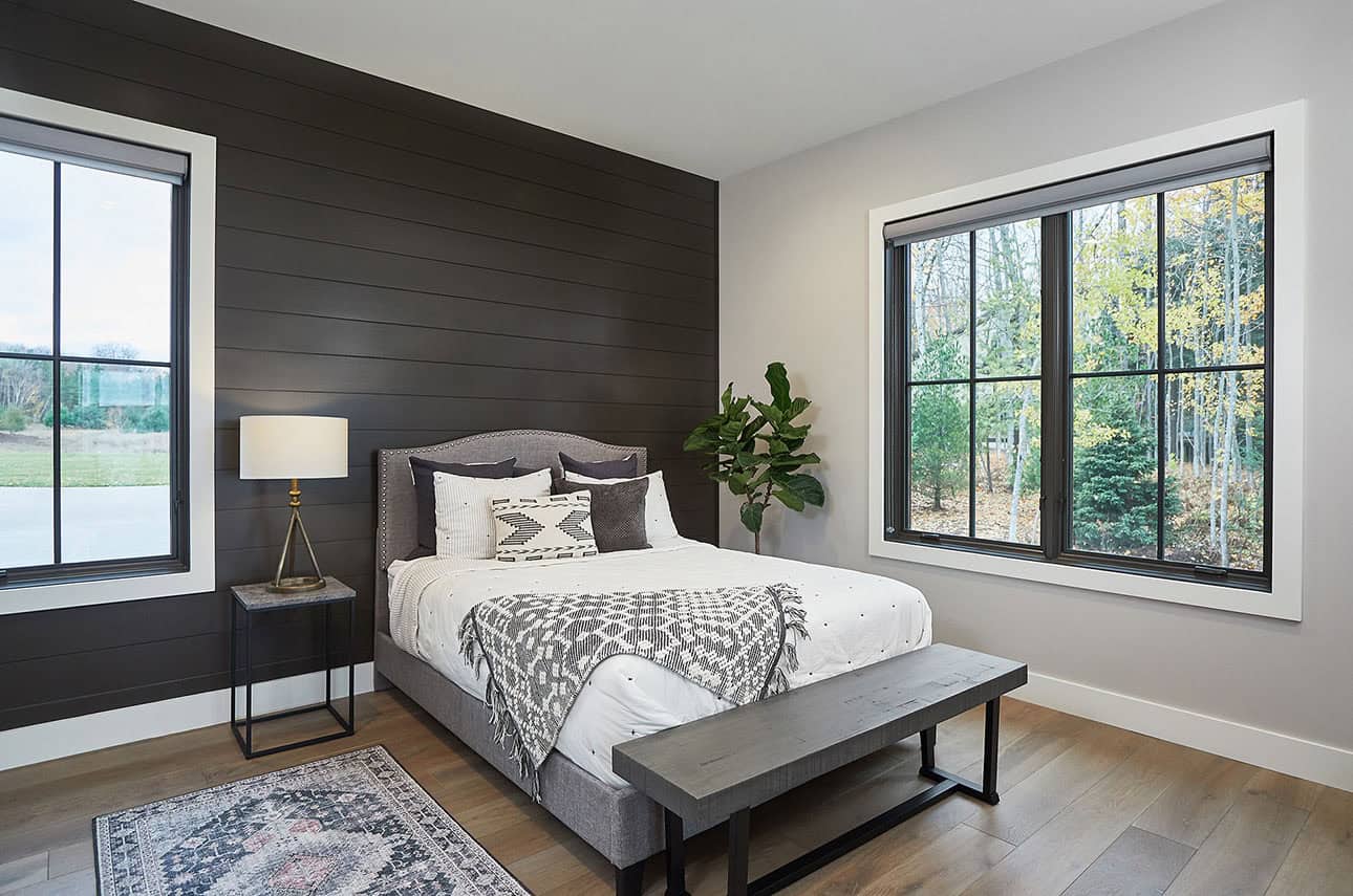 mountain style bedroom with a black accent wall