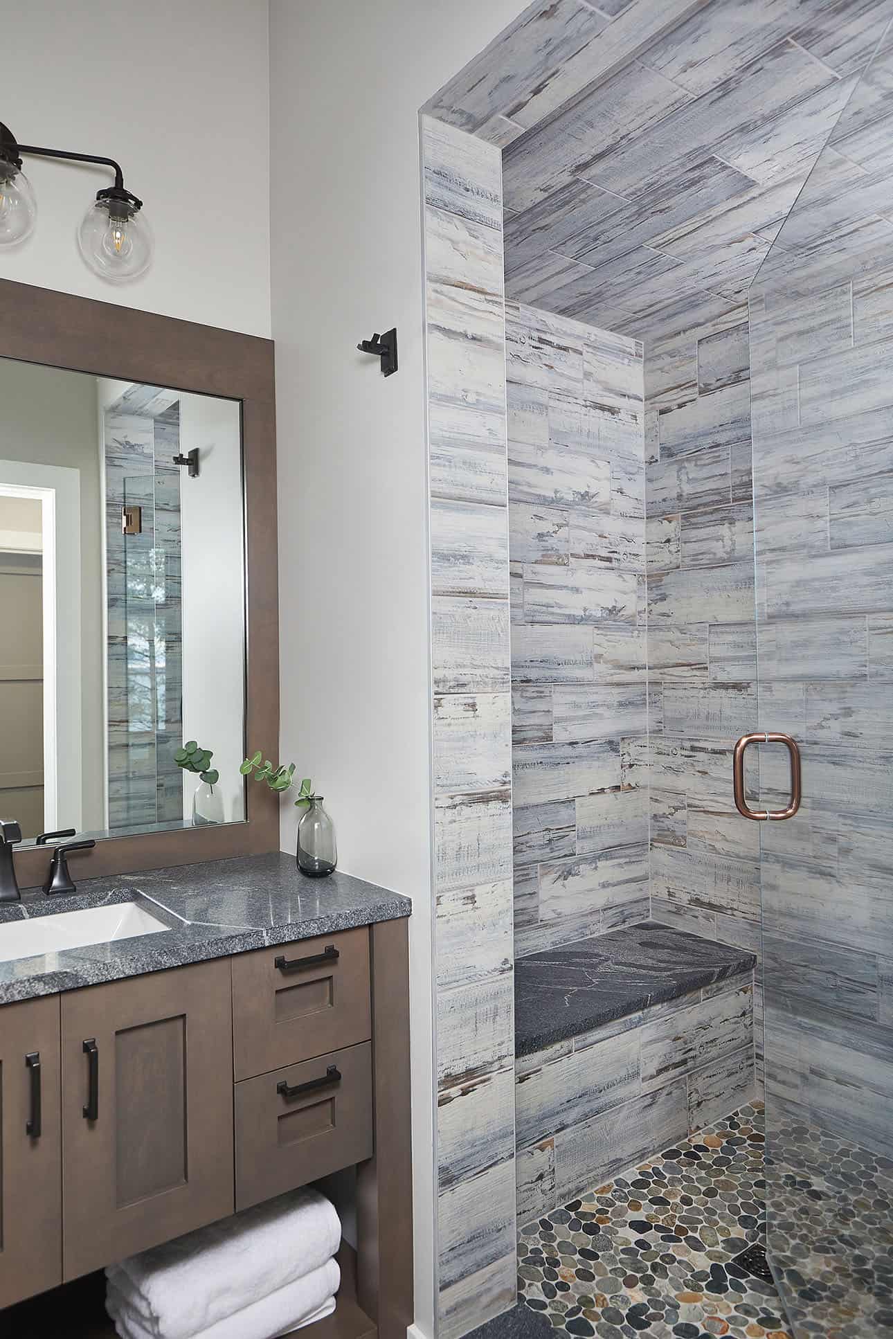 mountain style bathroom with a vanity and shower
