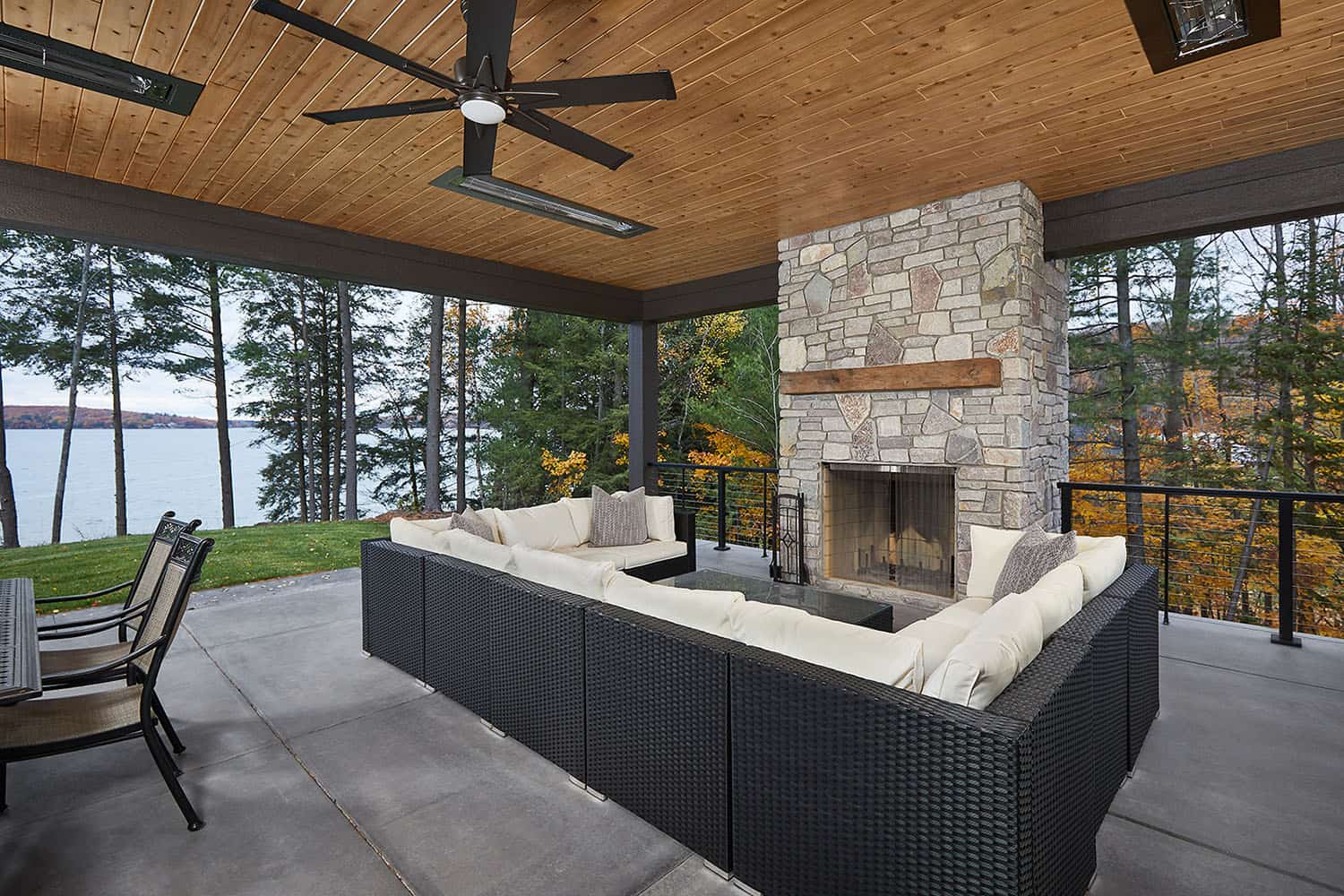 mountain style covered patio with outdoor furniture and a fireplace