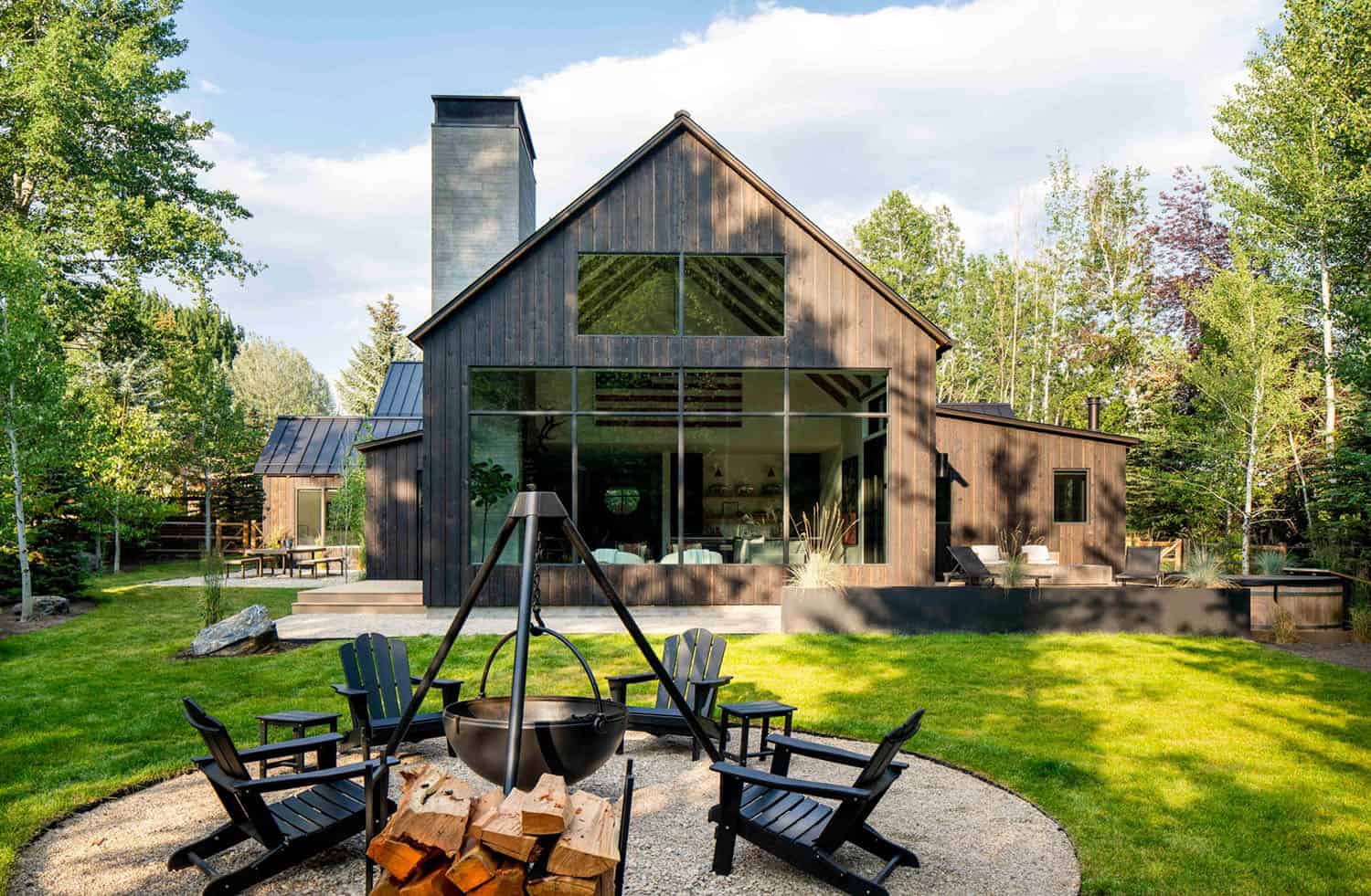 modern mountain home exterior with a fire pit