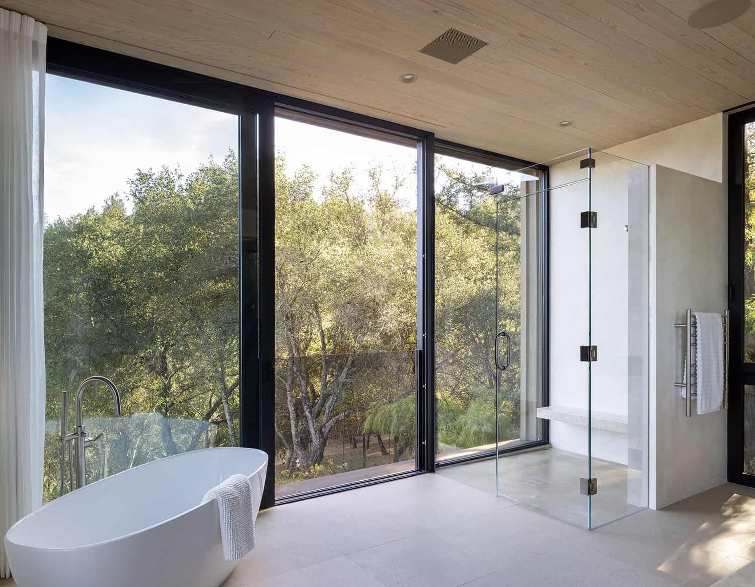 modern farmhouse bathroom with a freestanding tub and sliding glass doors