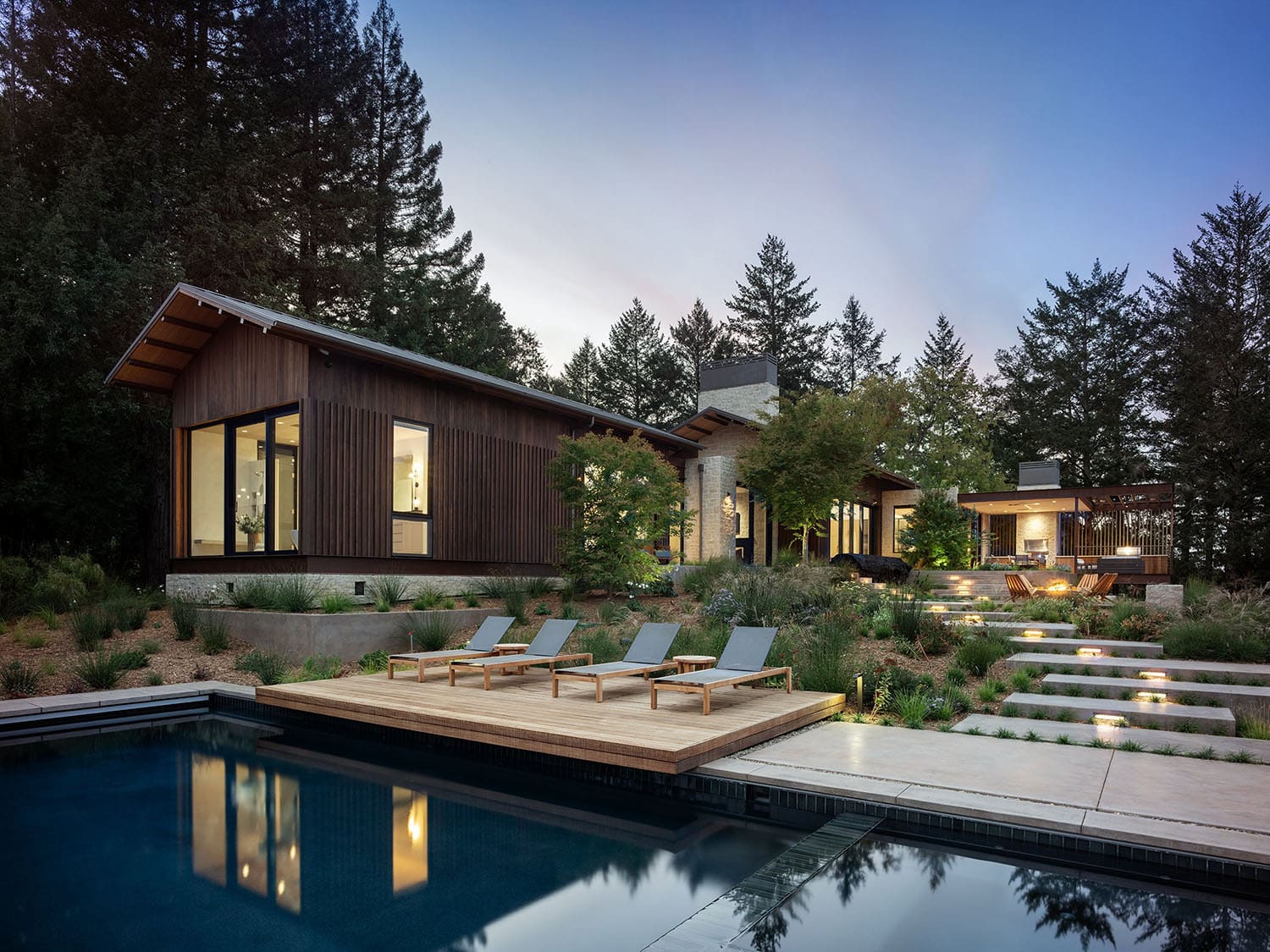 modern farmhouse home exterior with a pool
