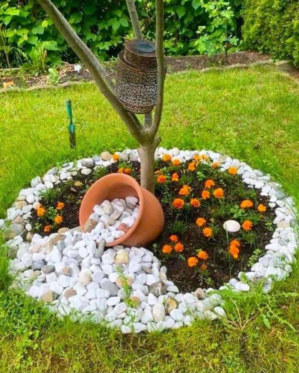 white rocks spilling out of a pot in a flower bed