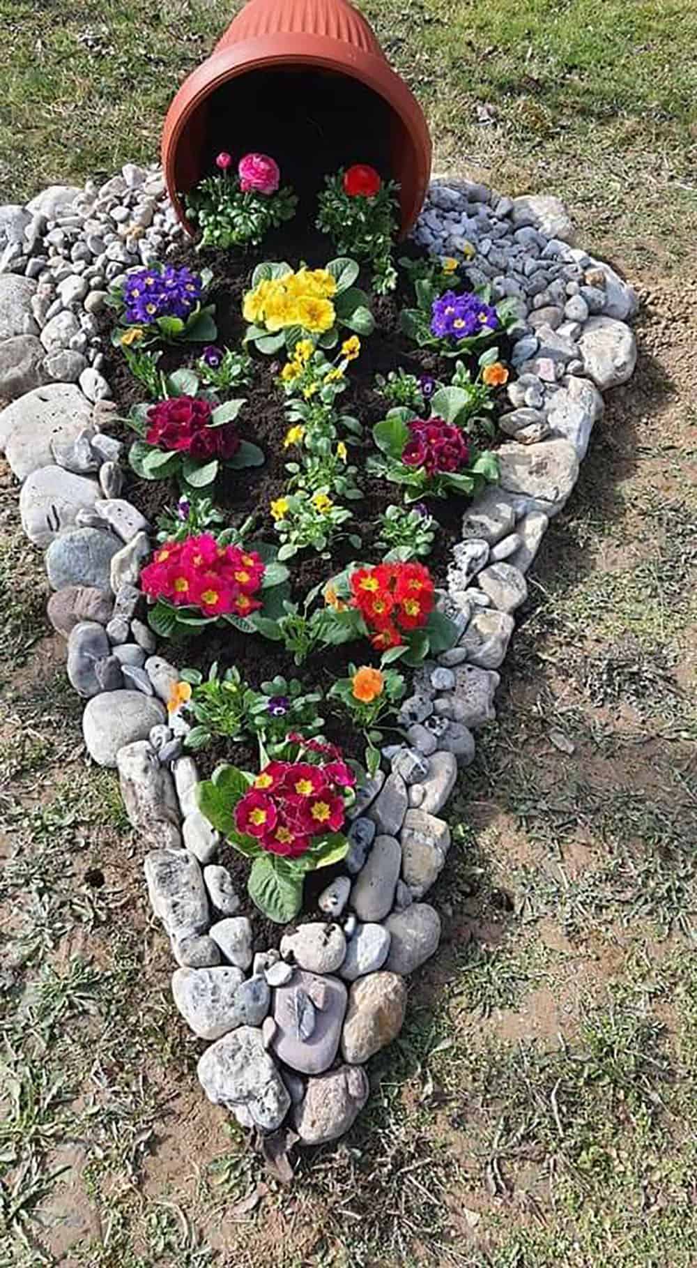spilled flower pot garden bed with colorful flowers