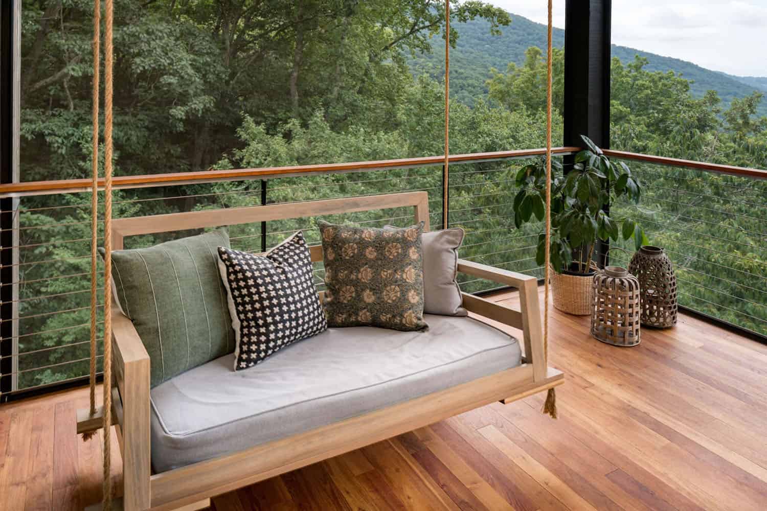 sustainable home exterior covered deck with a hanging daybed