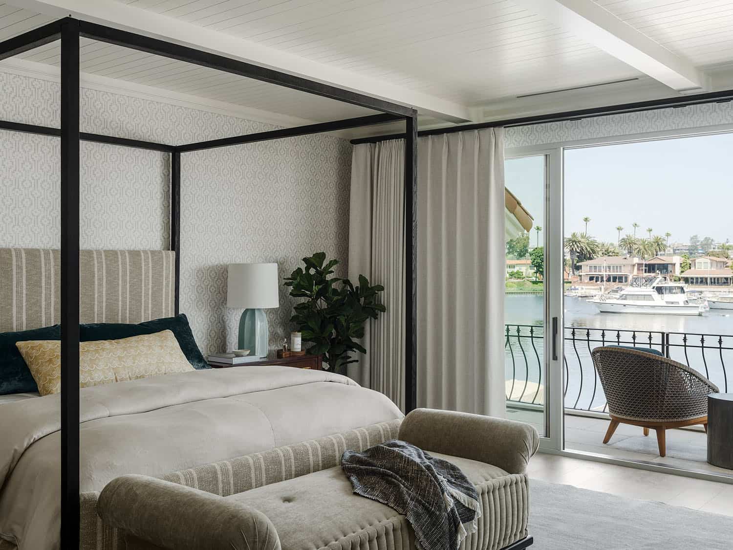 contemporary bedroom with sliding glass doors leading out to a private balcony