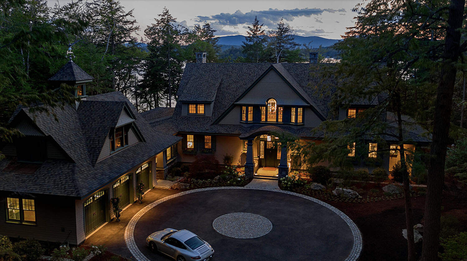 traditional style lake house exterior at dusk