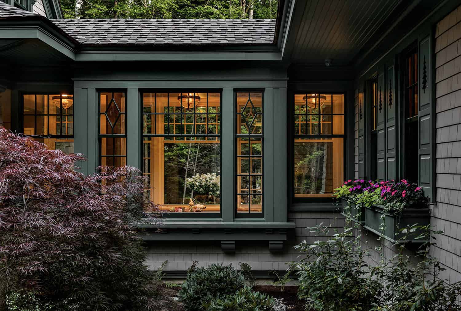 traditional style lake house exterior at dusk