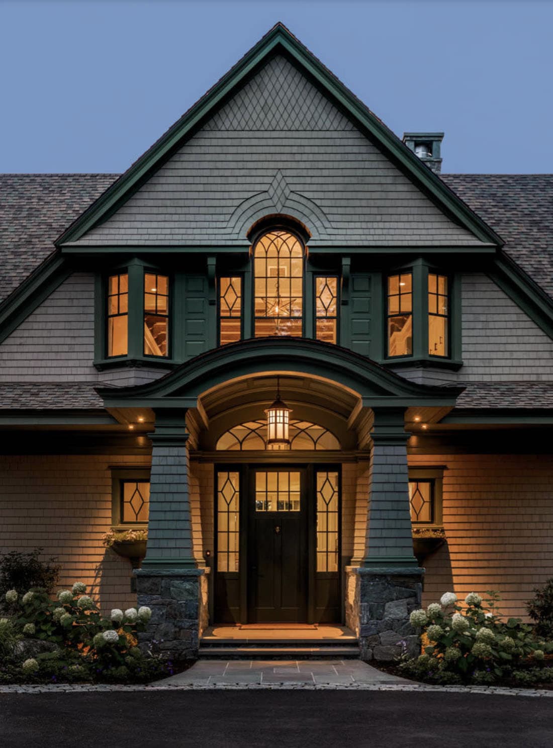 traditional style lake house exterior entry at dusk