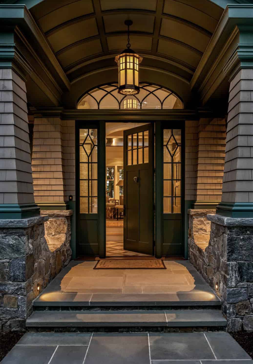 traditional style lake house exterior entry at dusk