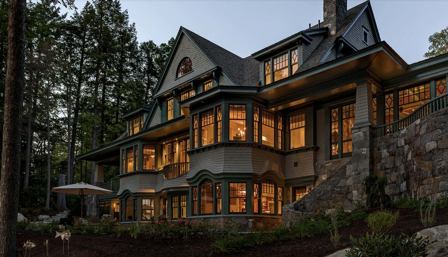traditional style lake house exterior backyard view at dusk