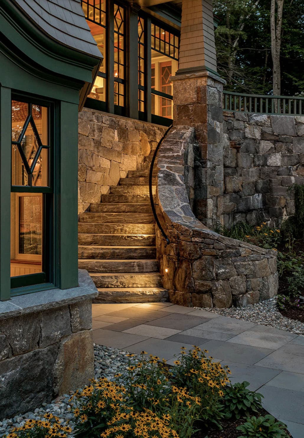 traditional style lake house exterior backyard view at dusk
