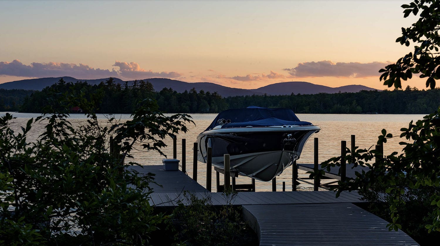 traditional style lake house exterior with a boat dock