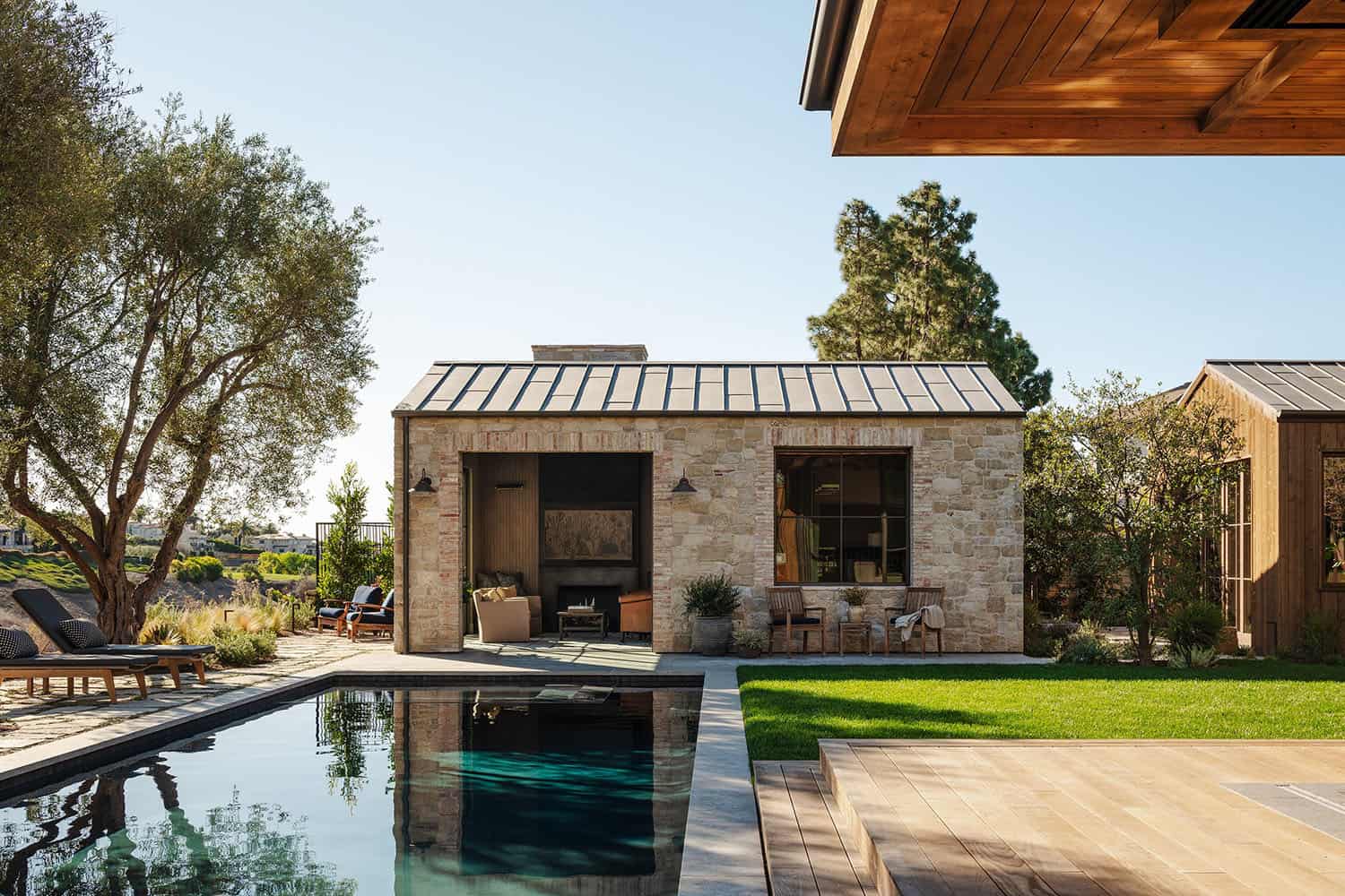 farmhouse style home exterior with a pool