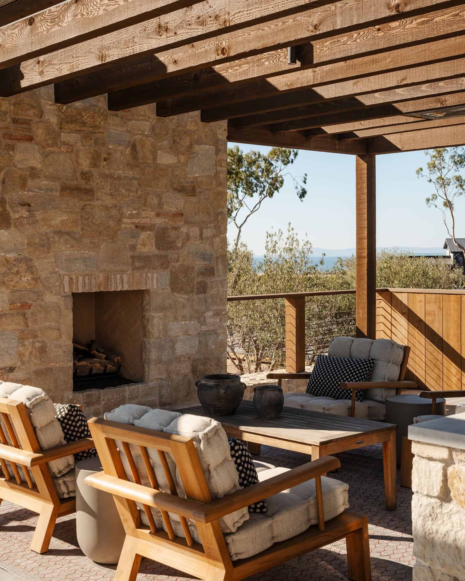 farmhouse style home exterior with a covered patio and fireplace