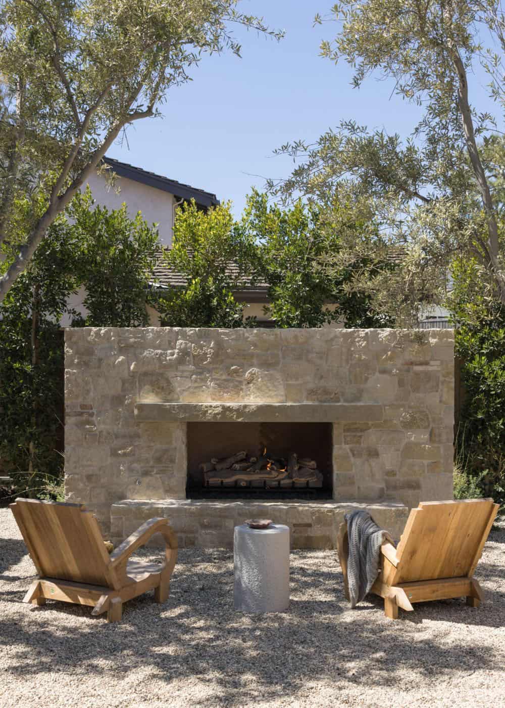 farmhouse style home exterior patio with a fireplace and outdoor furniture