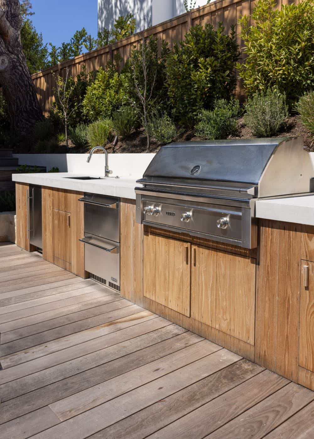 farmhouse style home with an outdoor kitchen and grill