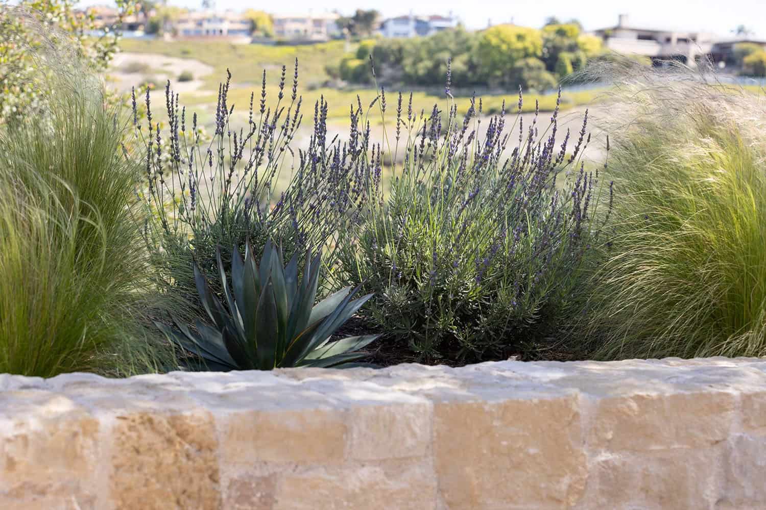farmhouse style home landscape with a retaining wall