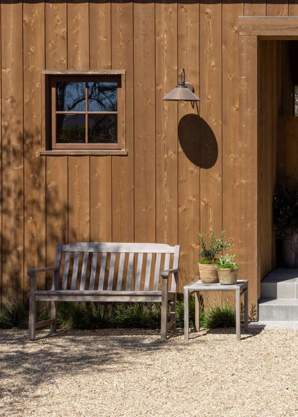 farmhouse style home exterior with a bench
