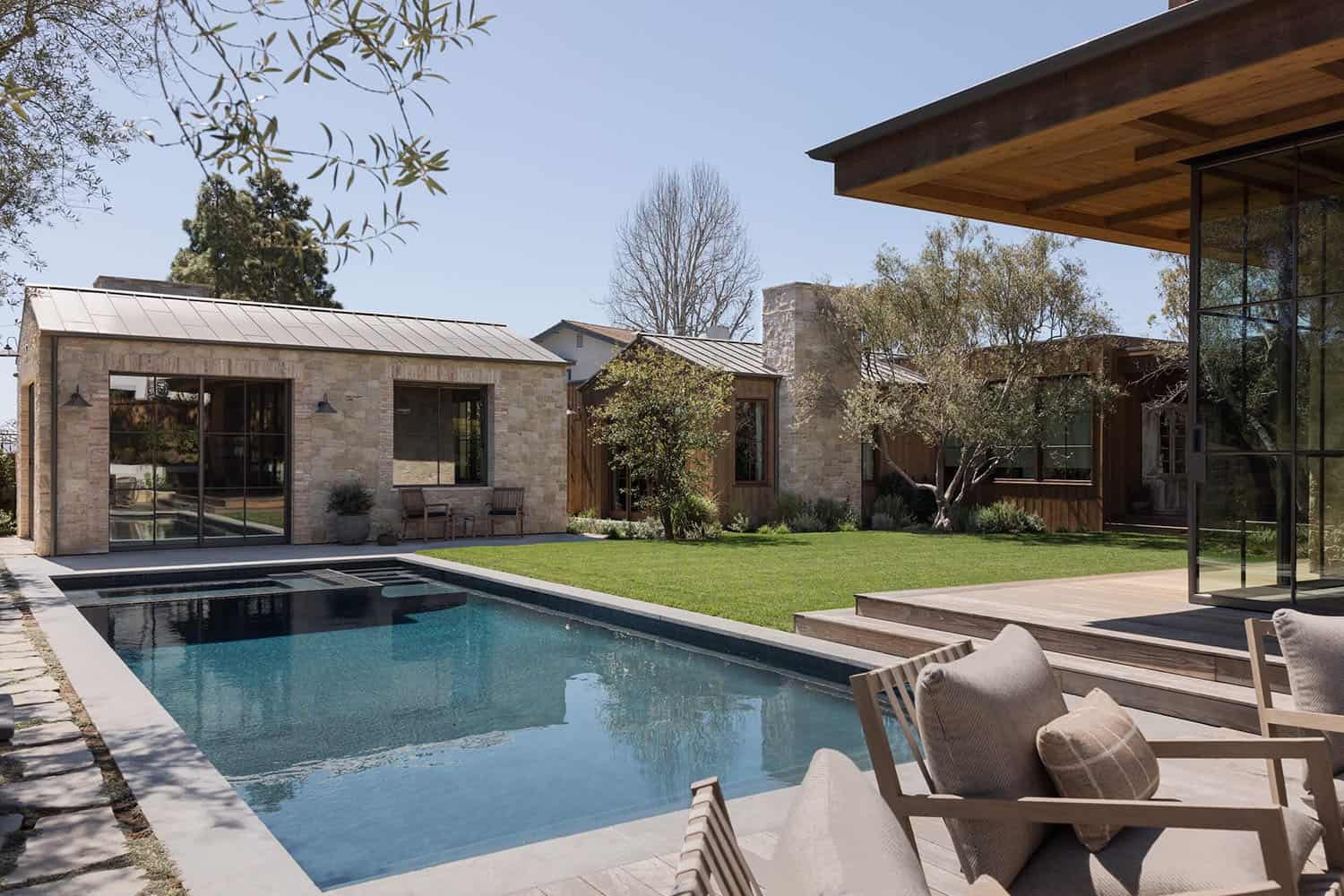 farmhouse style home exterior with a pool