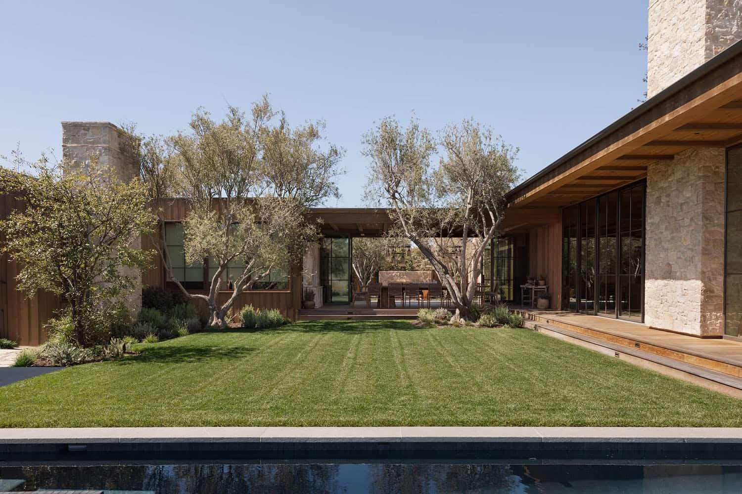 farmhouse style home exterior with a pool