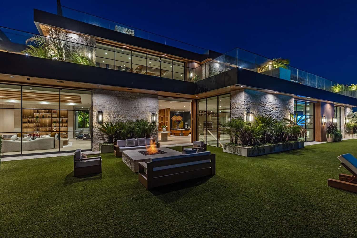 hillside home patio with a fire pit and outdoor furniture