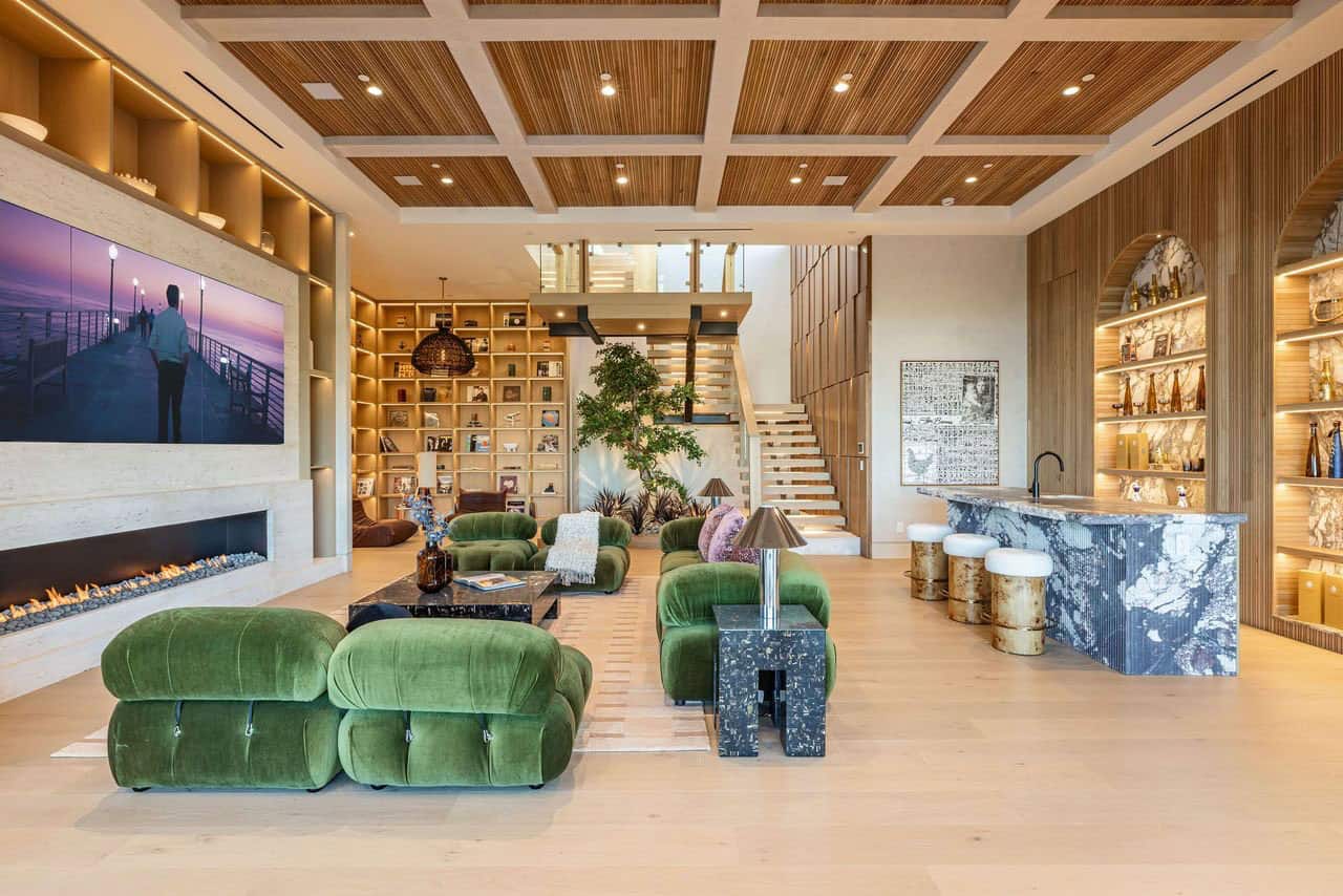modern lower-level family room with a fireplace and home bar