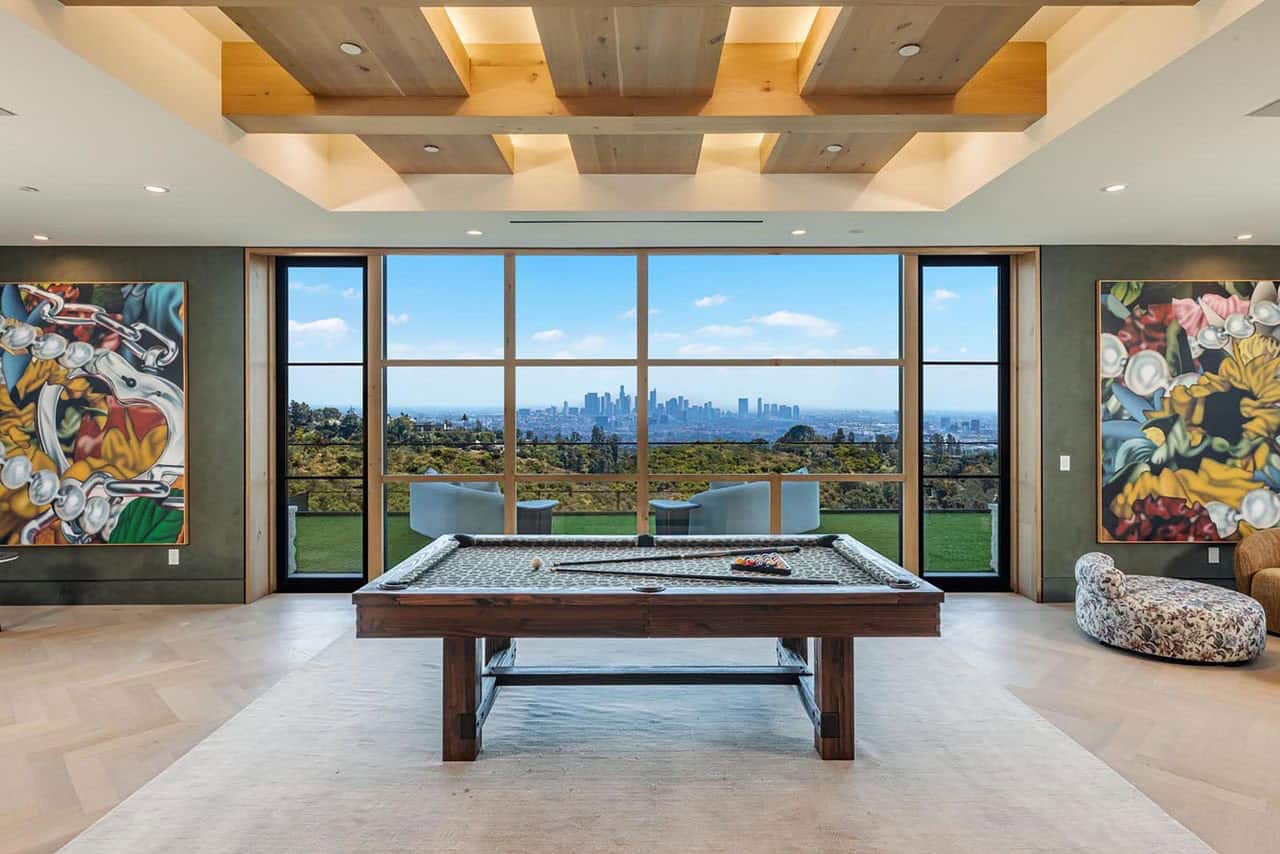 modern lower-level family room with a pool table and large window