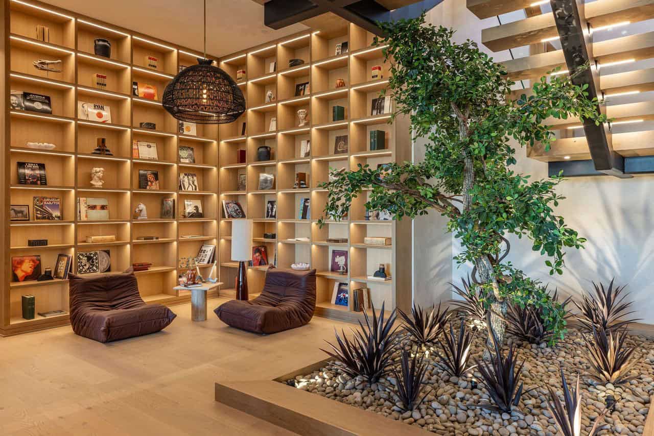 modern home library with lounge chairs and an indoor garden