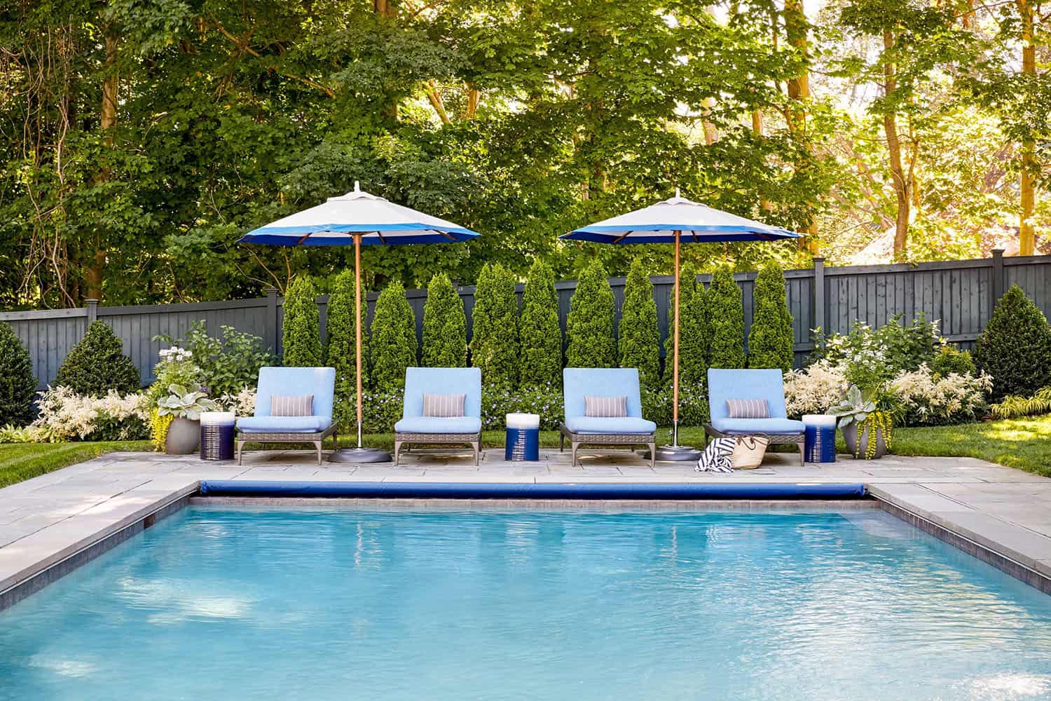 farmhouse style home with chaise lounge chairs and a pool