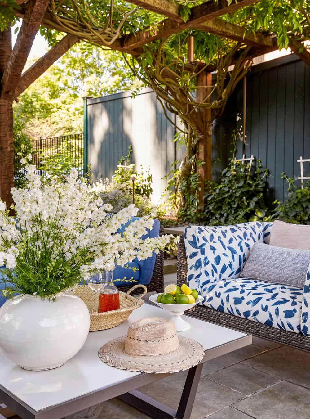farmhouse style pergola with outdoor furniture