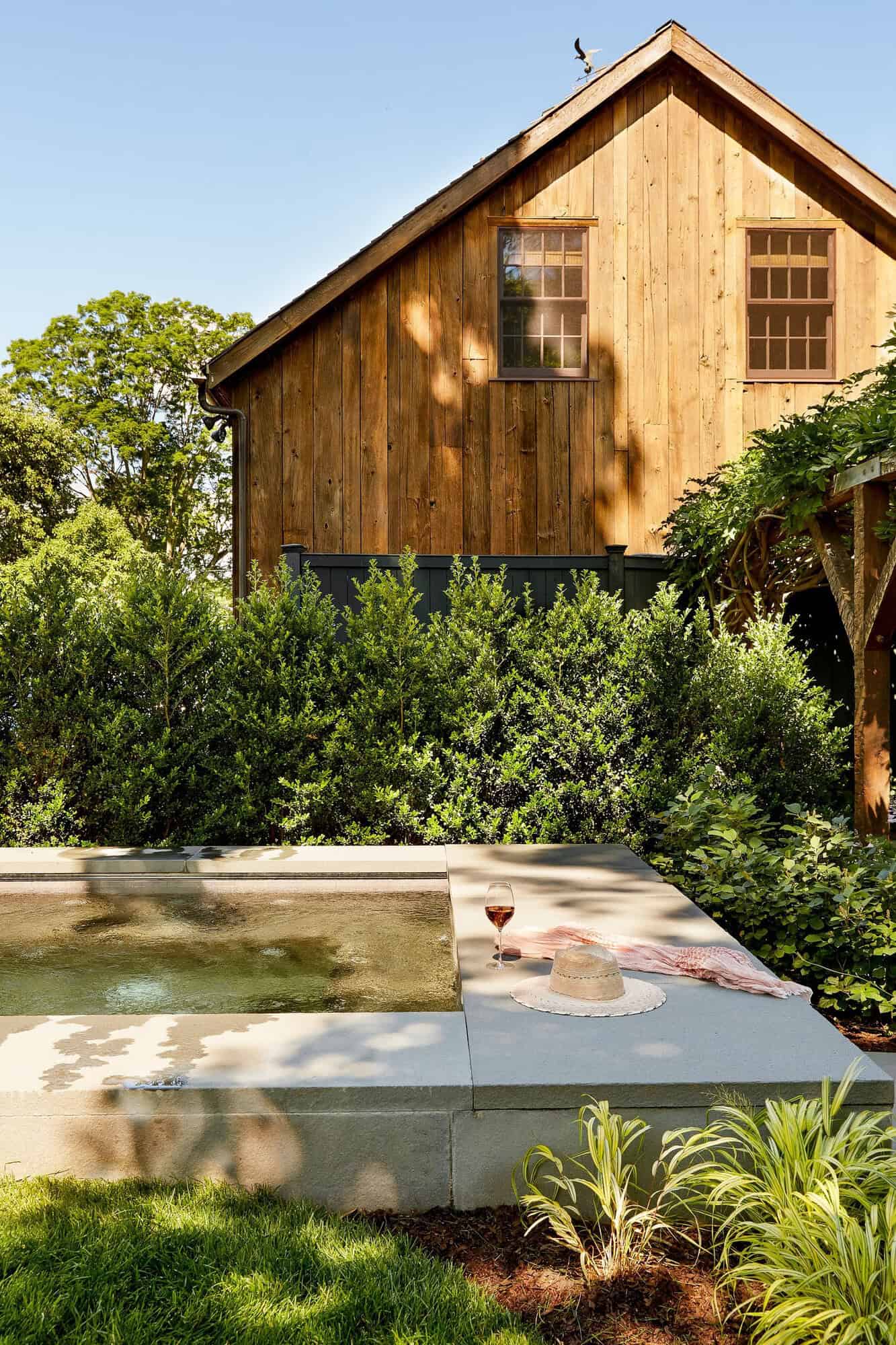 farmhouse style home landscape with a spa