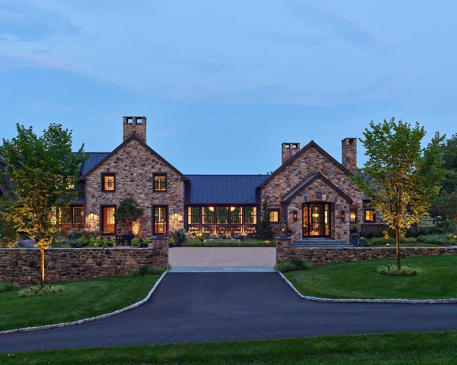 contemporary farmhouse home exterior at dusk