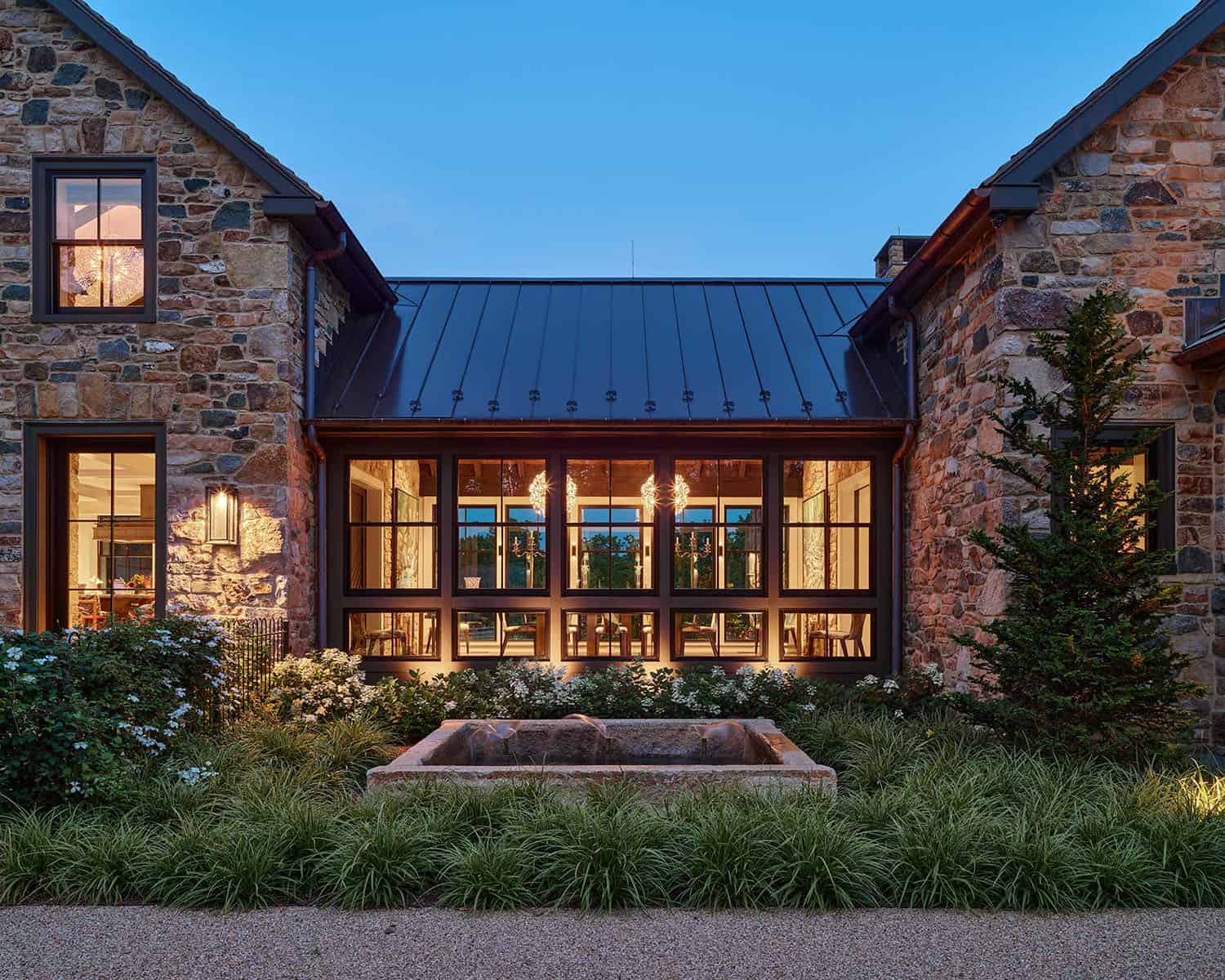 contemporary farmhouse home exterior at dusk