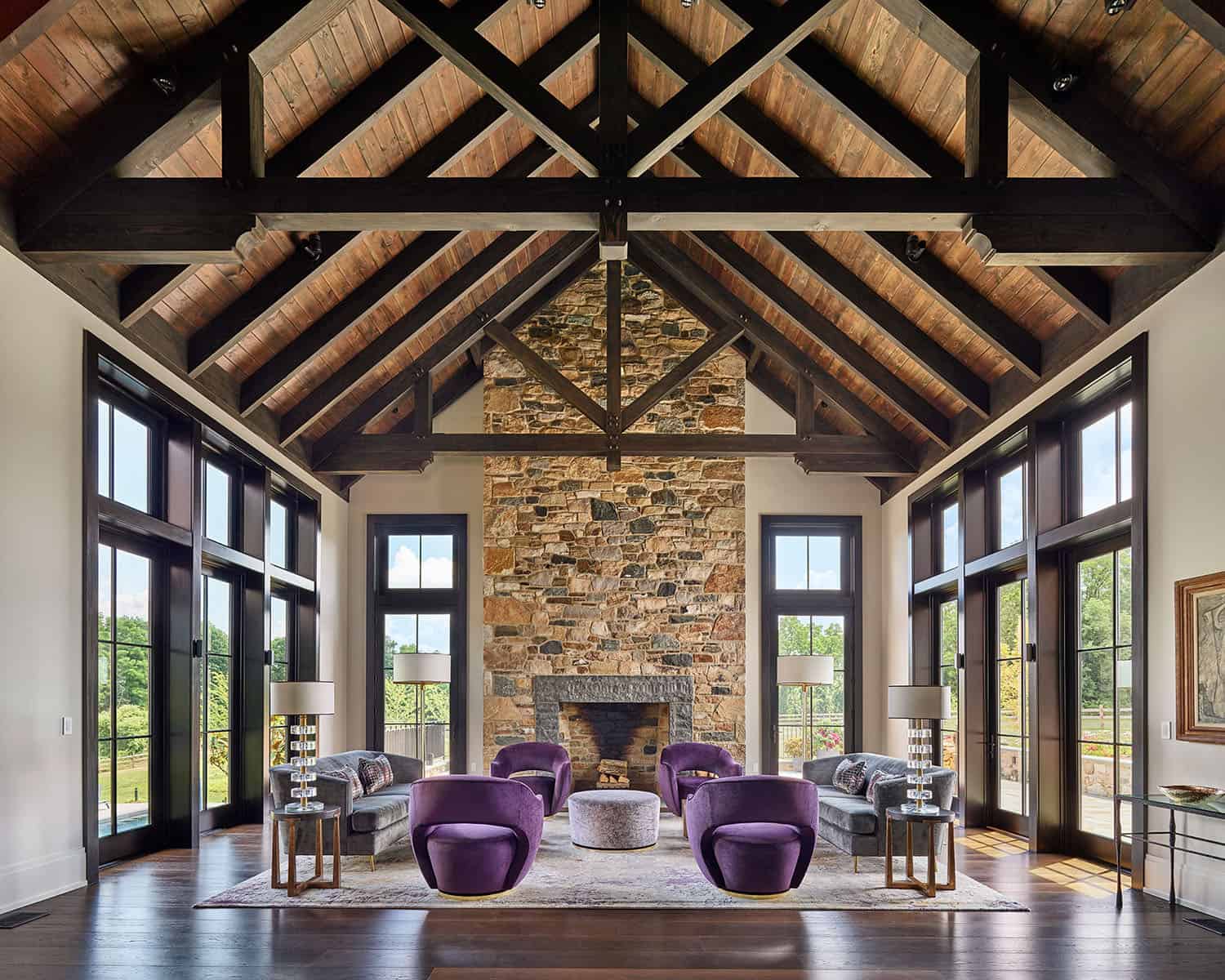 contemporary farmhouse style living room with a stone fireplace and two-story ceiling