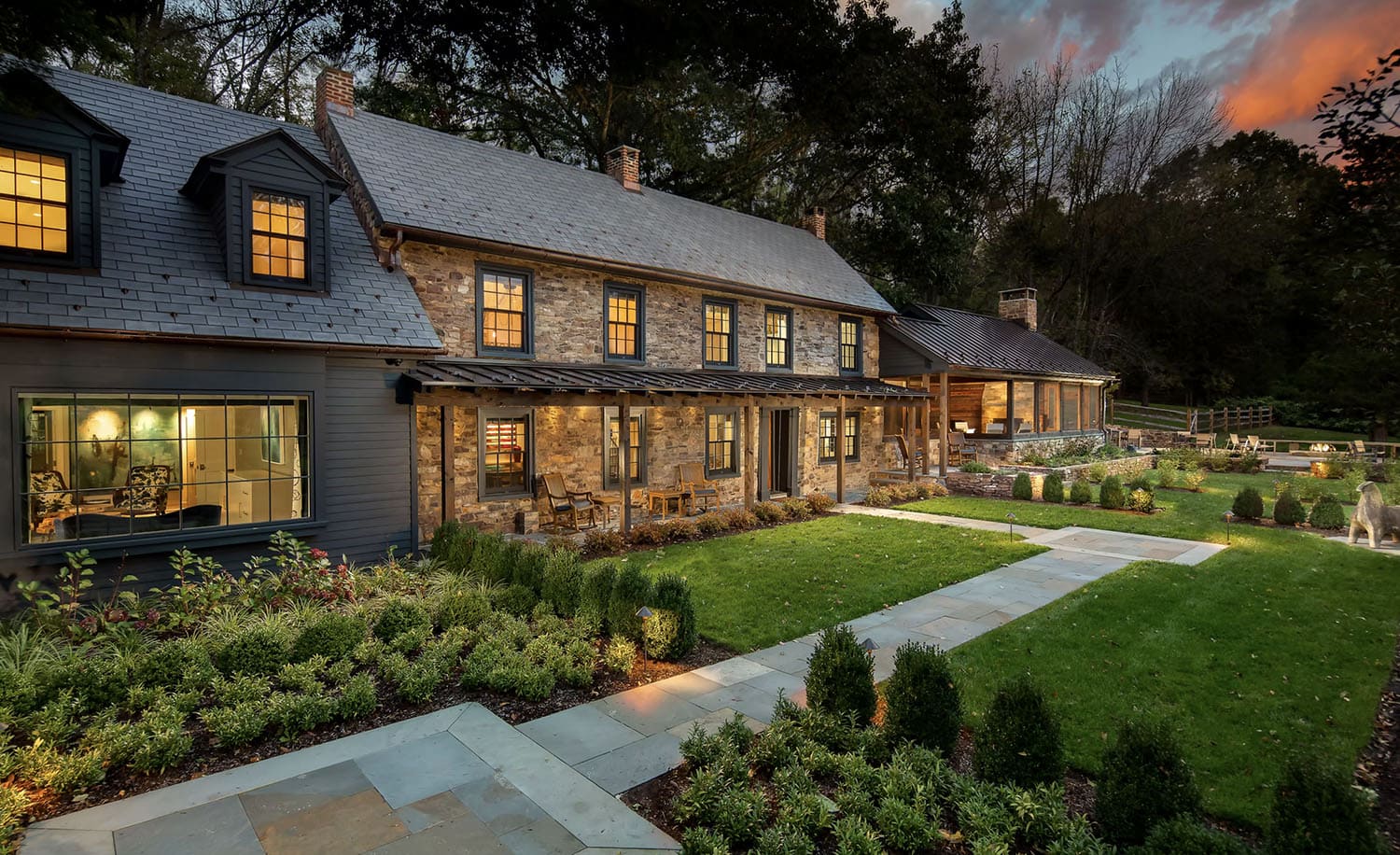 contemporary farmhouse style guest house exterior at dusk