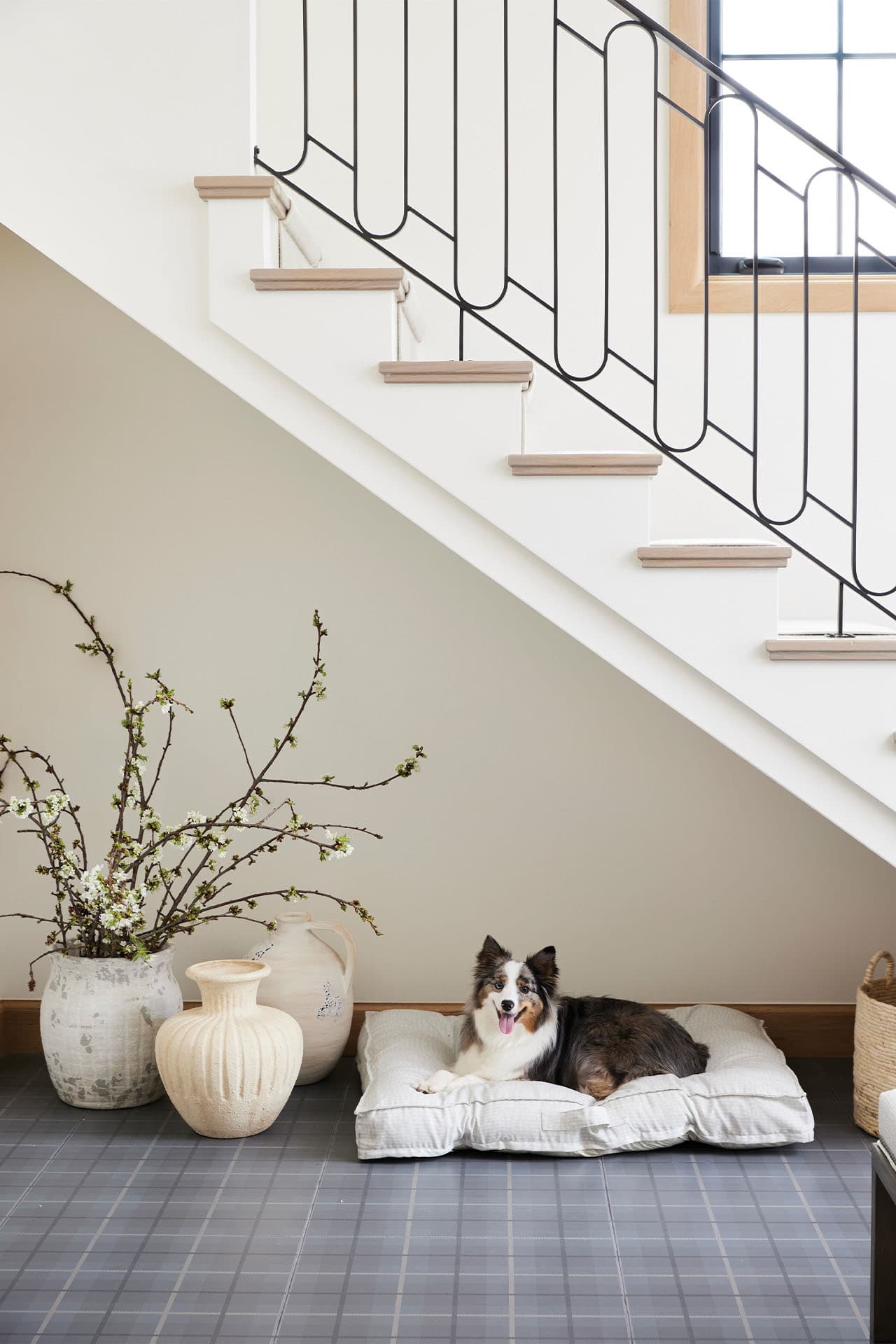 contemporary french country staircase with a dog bed underneath