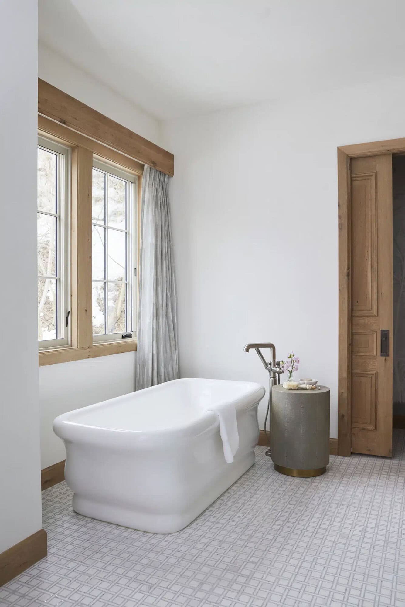 contemporary french country bathroom with a freestanding tub