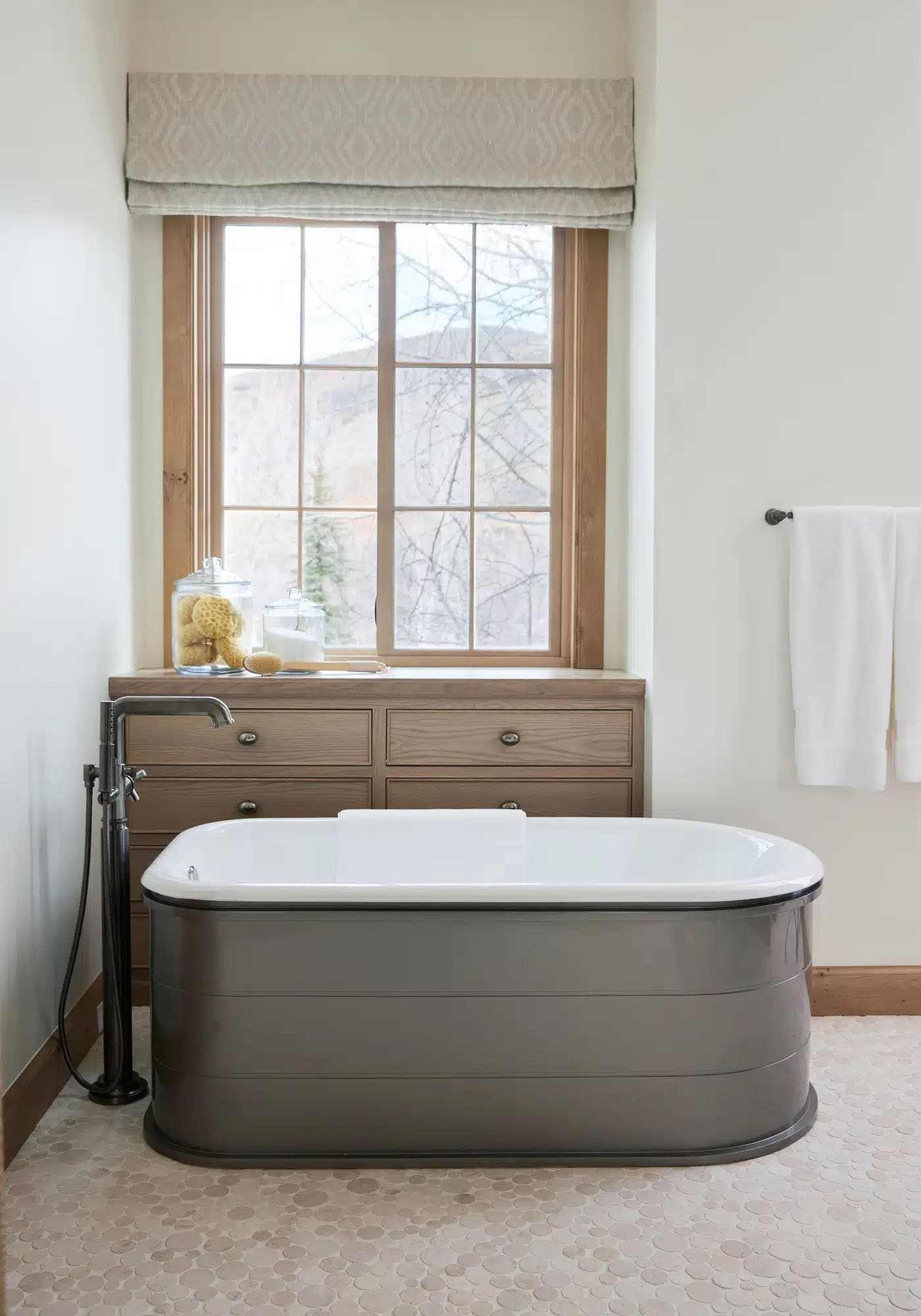 contemporary french country bathroom with a freestanding tub