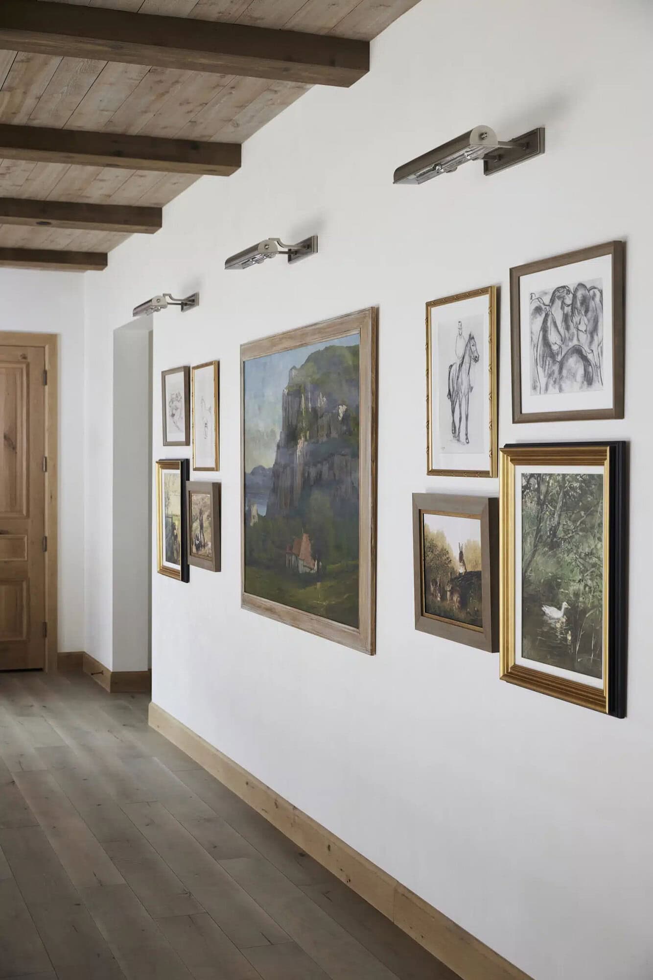 contemporary french country hallway with a gallery wall