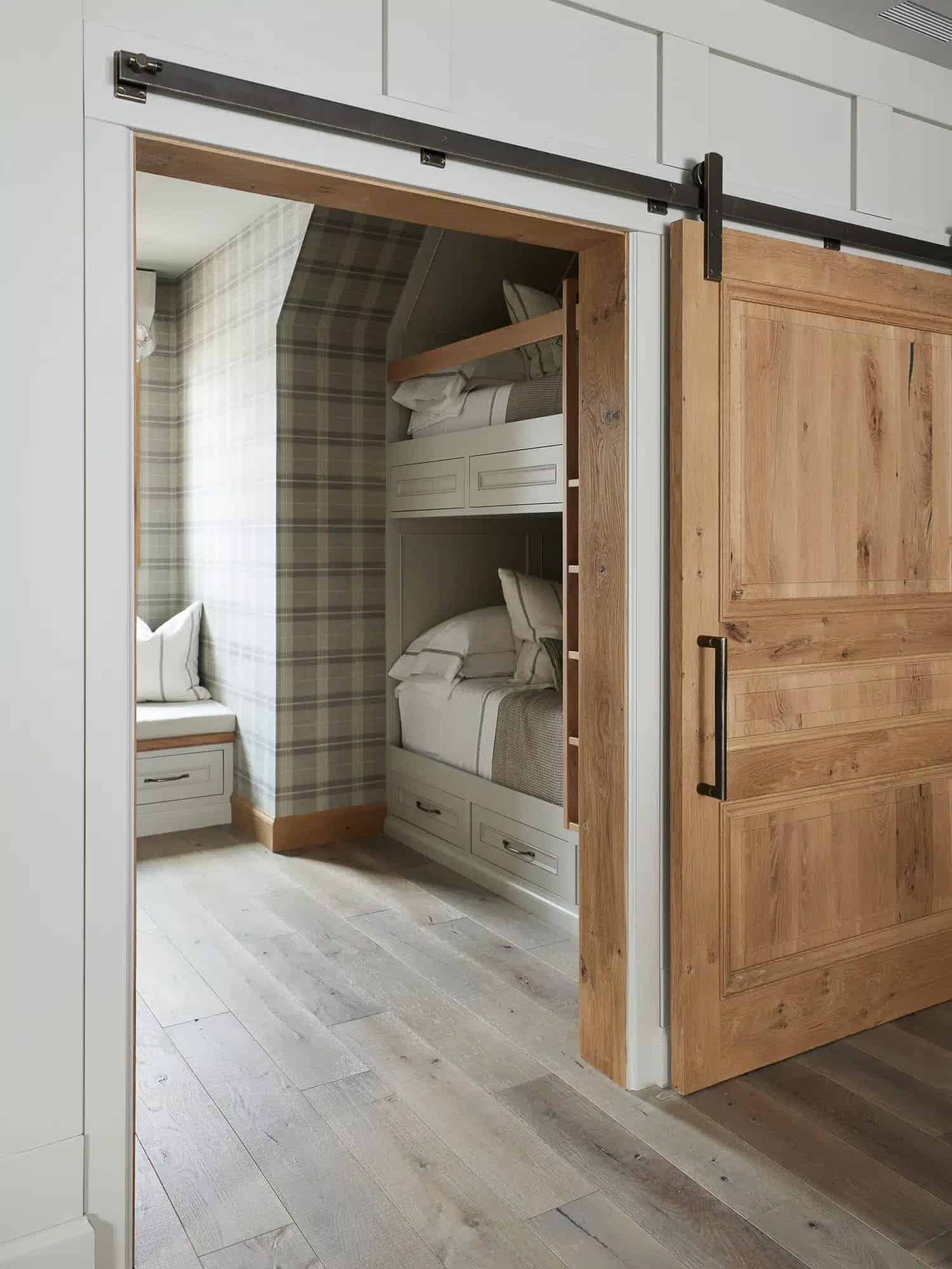 contemporary french country bunk bedroom with a sliding barn door
