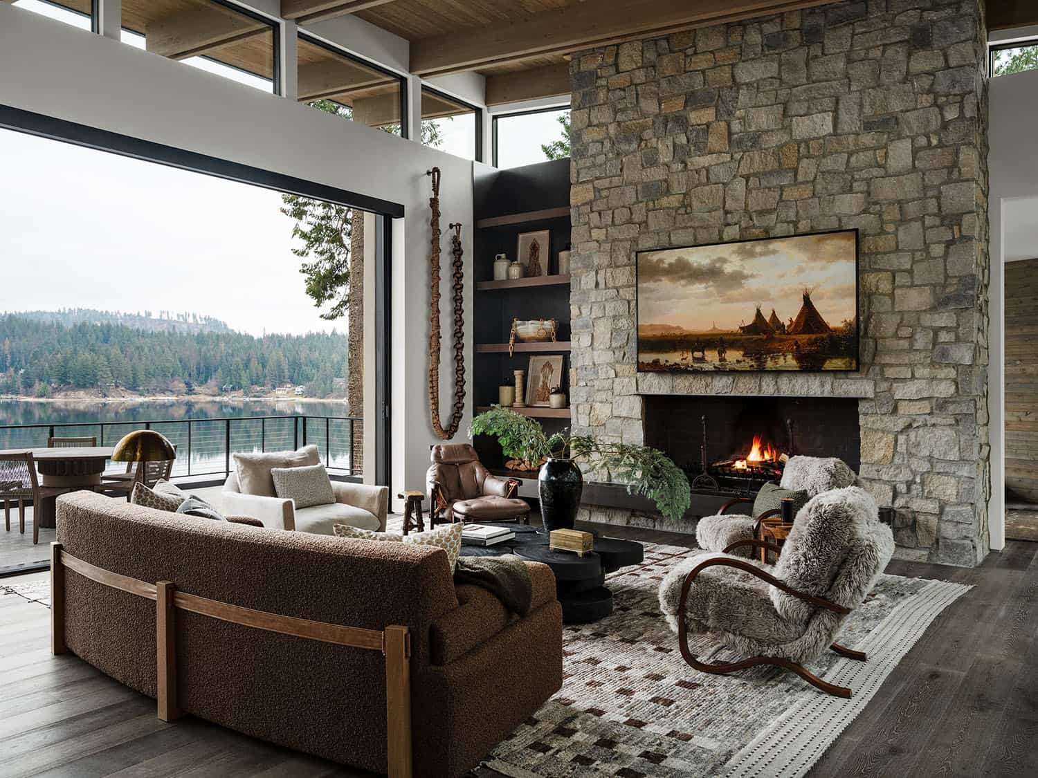 contemporary living room with a fireplace and lake views