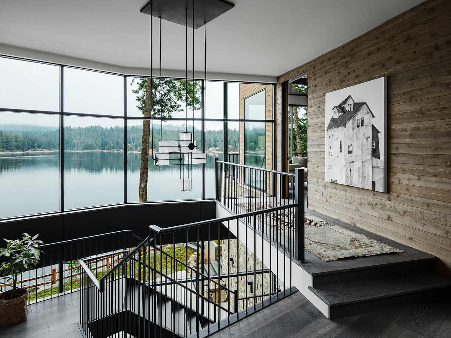 contemporary staircase with floor-to-ceiling windows and lake views