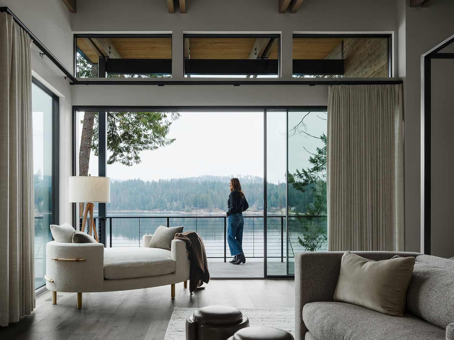 contemporary bedroom with a private balcony and lake views