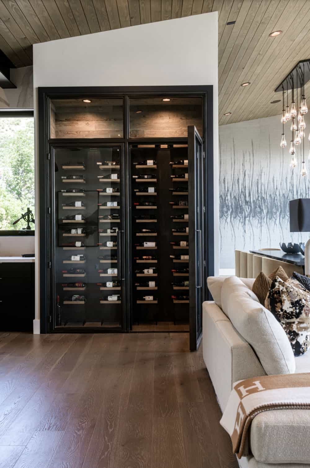contemporary living room with a wine wall
