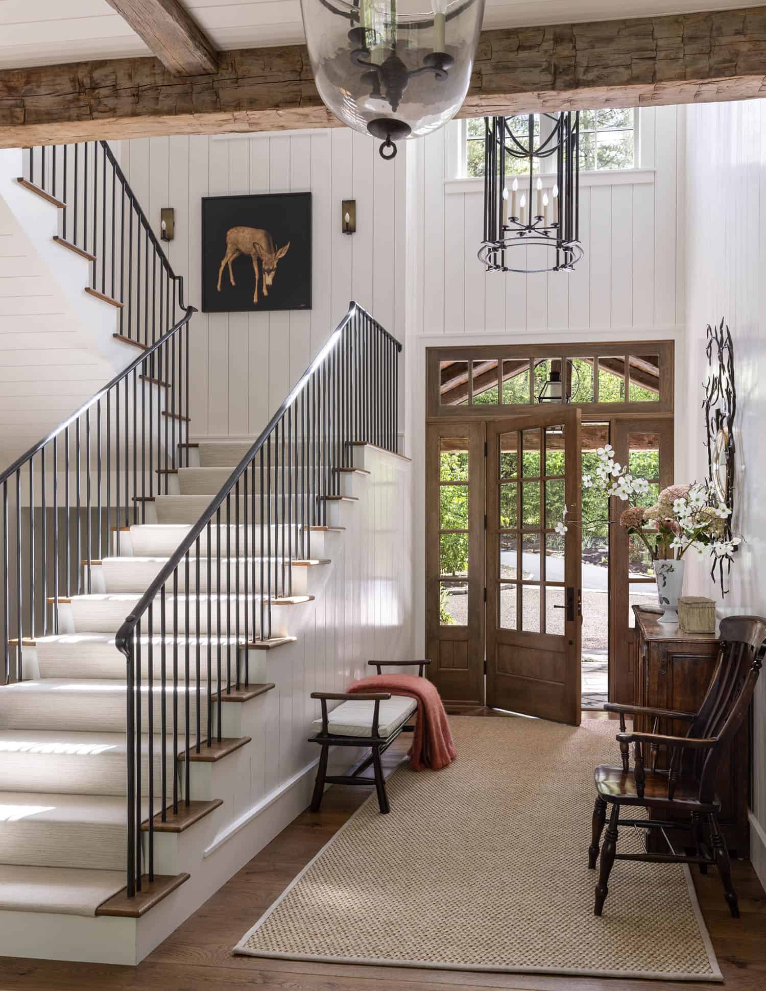 European-inspired home entry with wood doors and a staircase