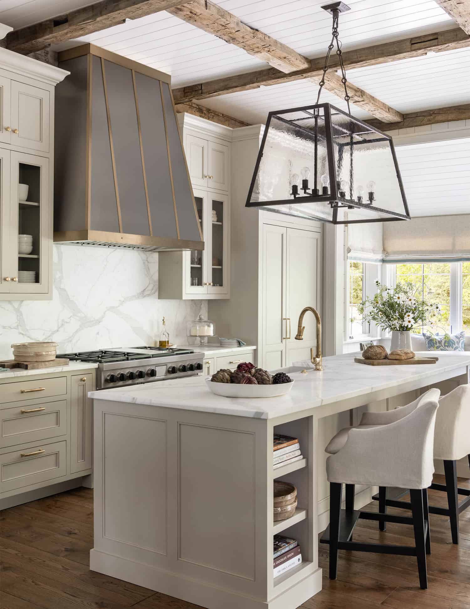 transitional style kitchen with a custom metal hood
