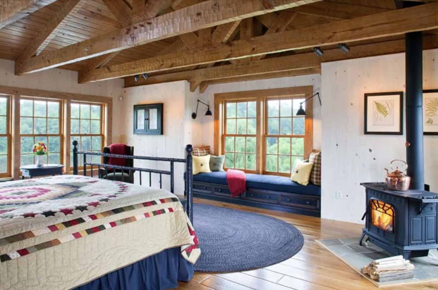 rustic bedroom with a fire stove and a window seat