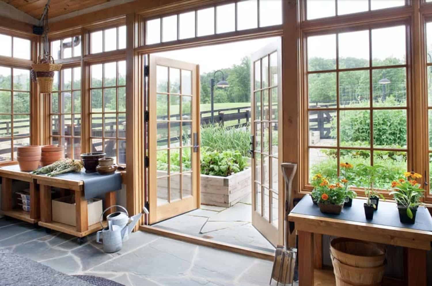 rustic sunroom with french doors leading out to a garden